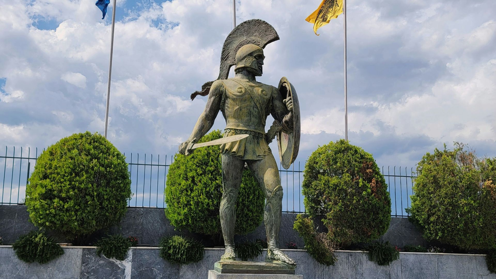 a statue of a man holding a shield and a shield