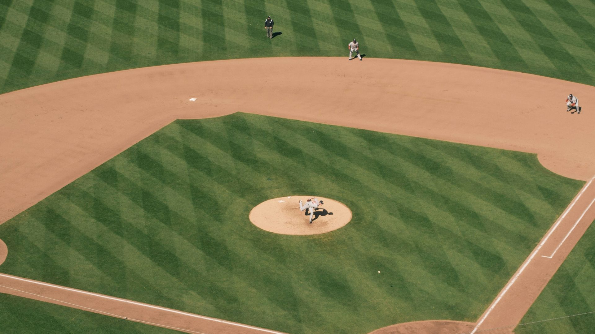 people playing baseball on field during daytime