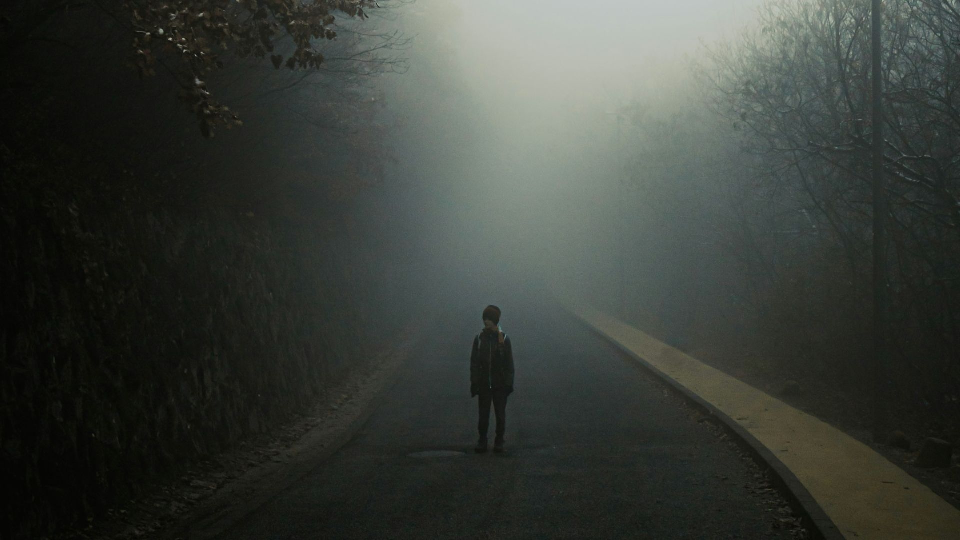 a person standing in the middle of a road