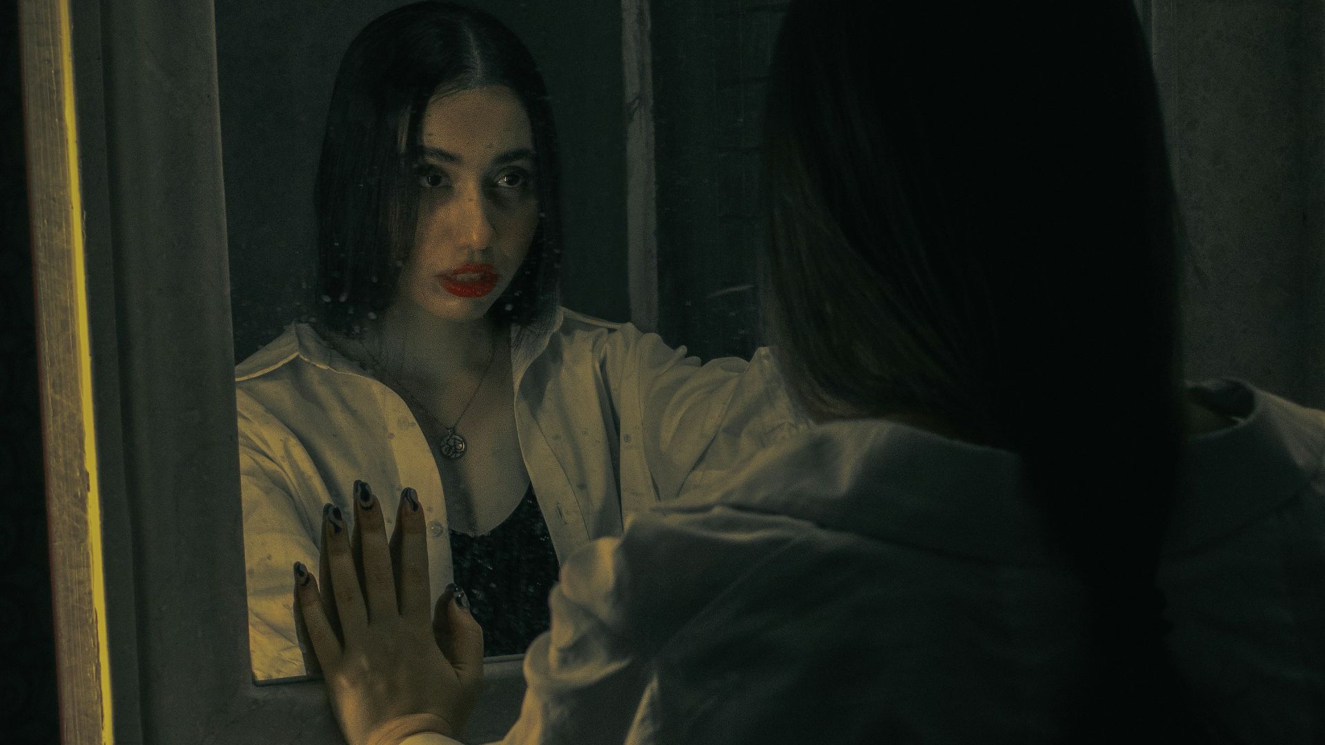 a woman standing in front of a mirror