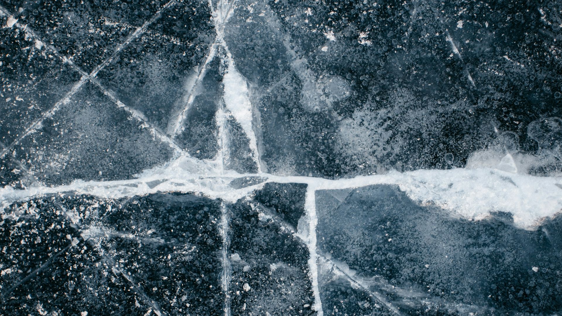 a black and white photo of a cross made of ice