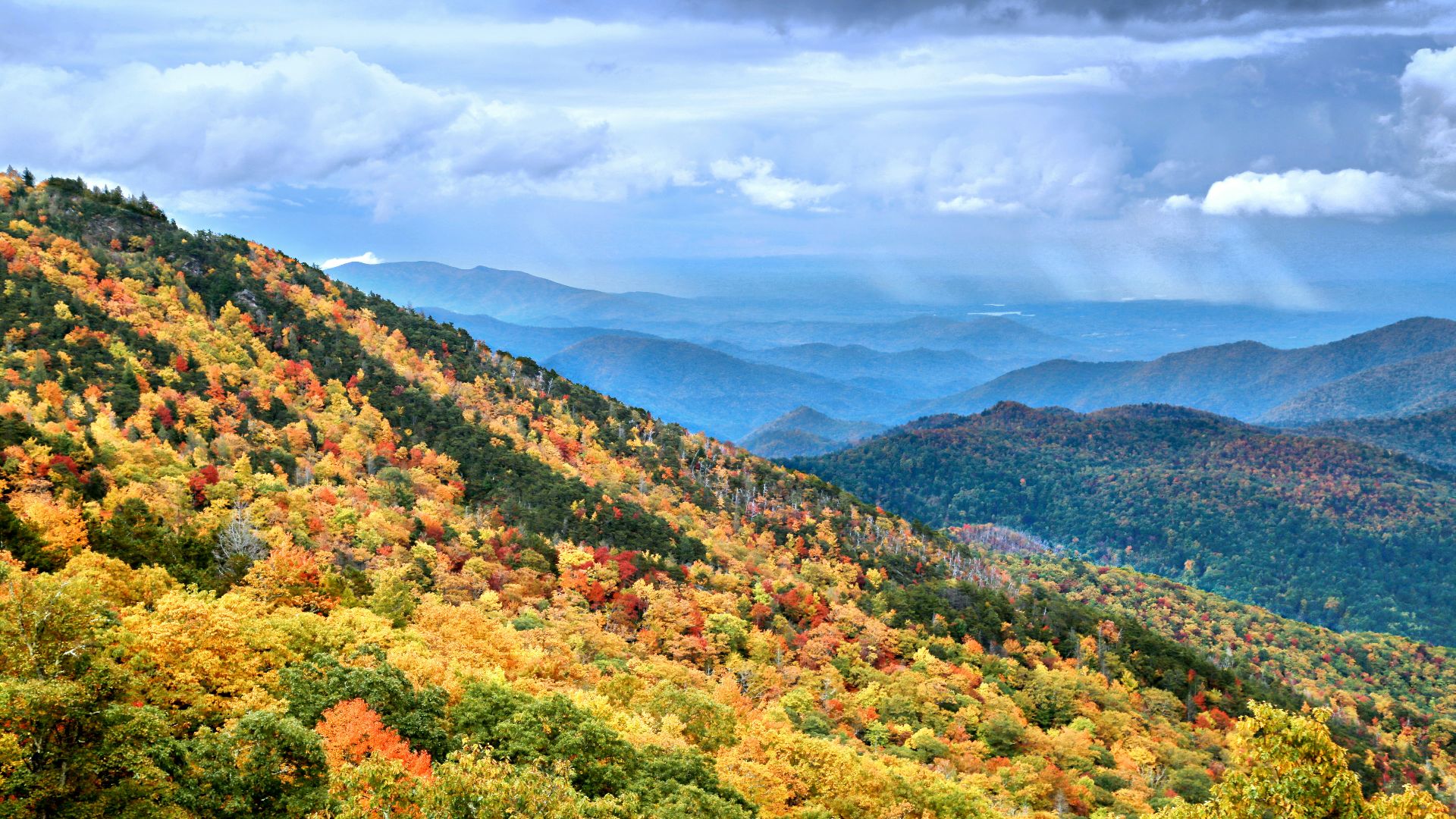 a scenic view of a mountain range in the fall
