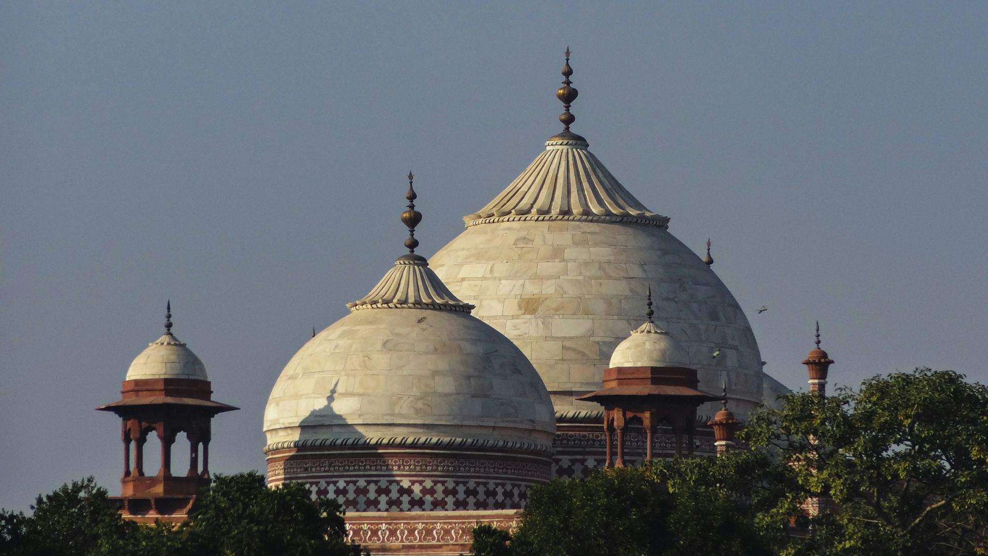 a large white building with two domes on top of it