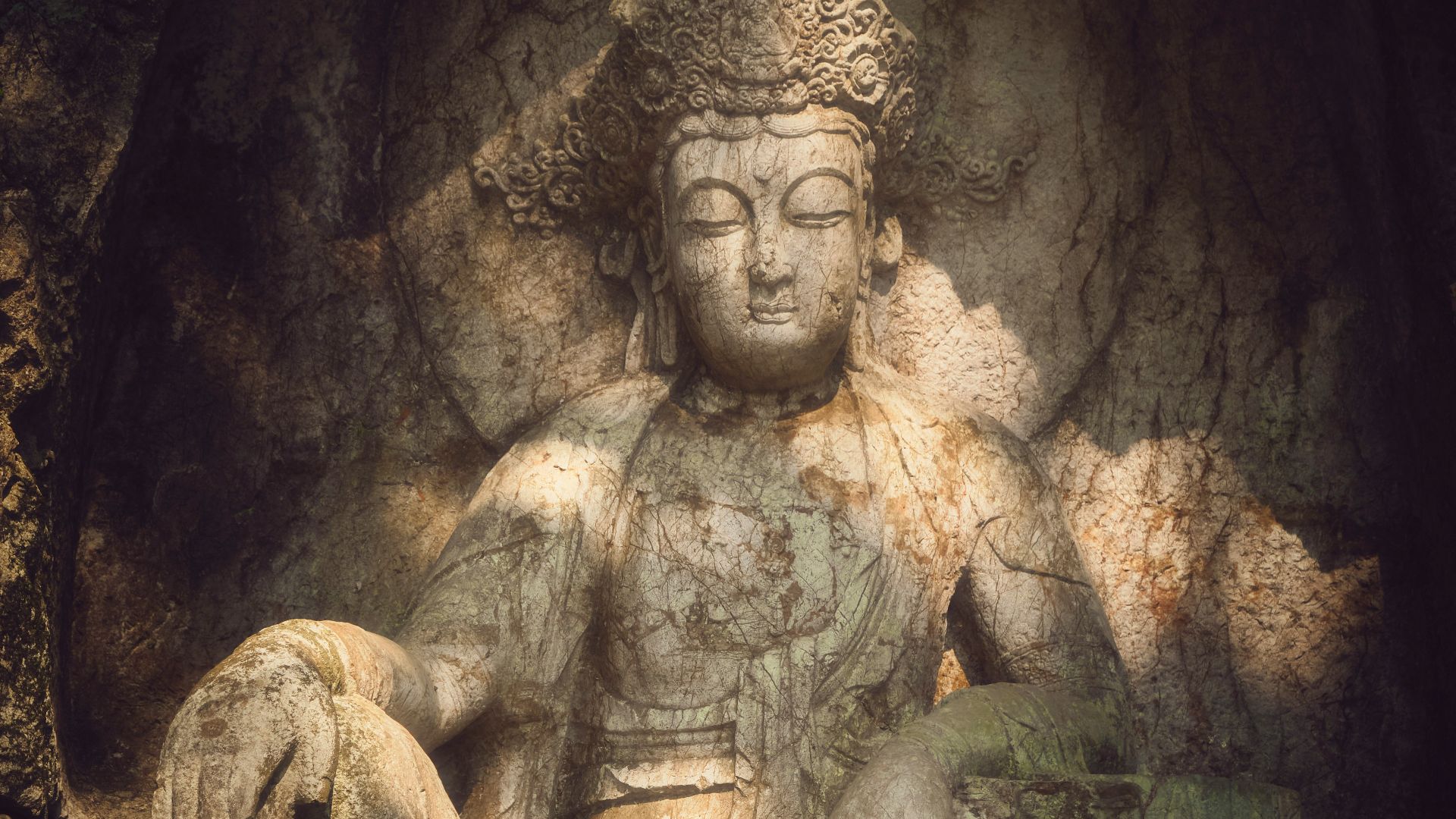 A carved buddha statue inside a cave.