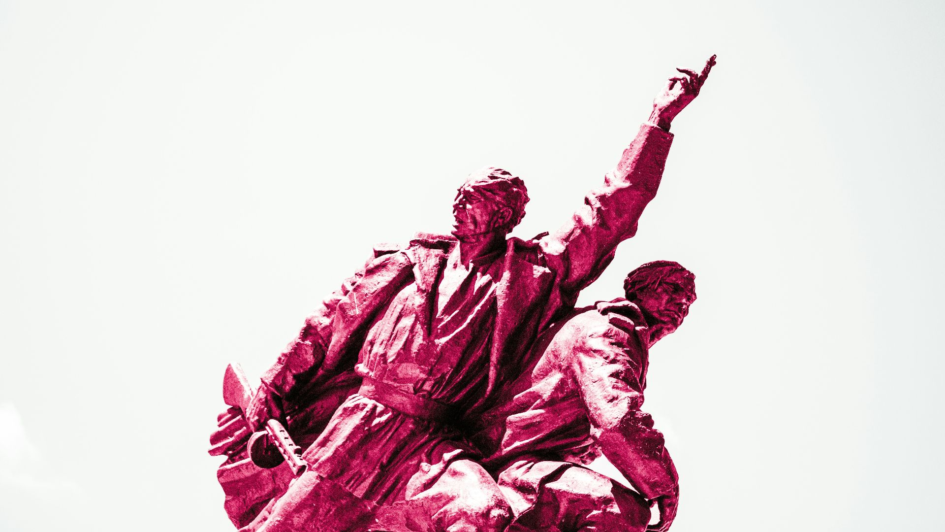 a statue of two men holding hands in front of a white sky