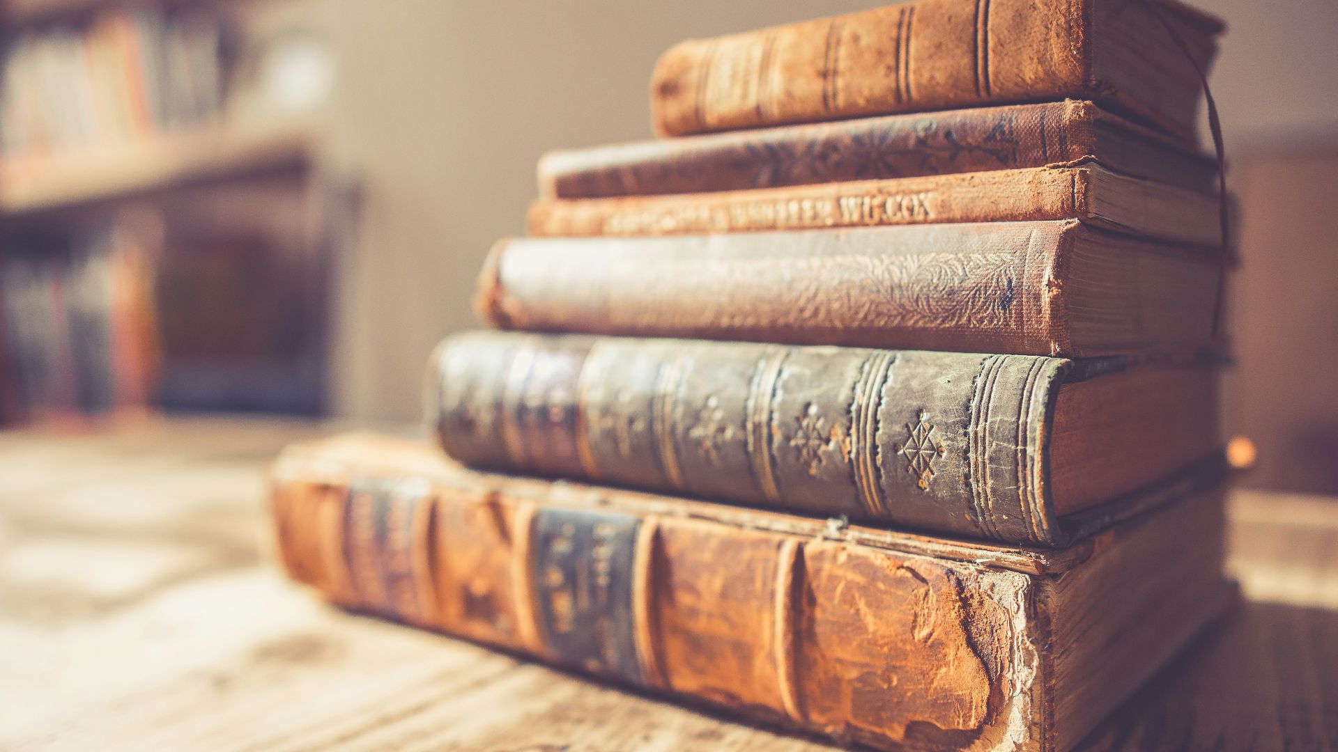 stack of six brown hardbound books