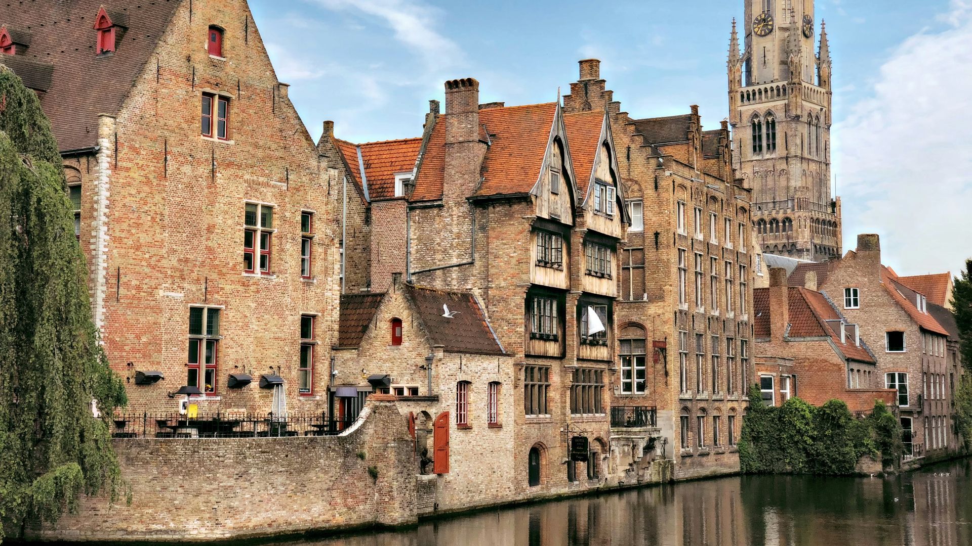 brown concrete building beside river during daytime