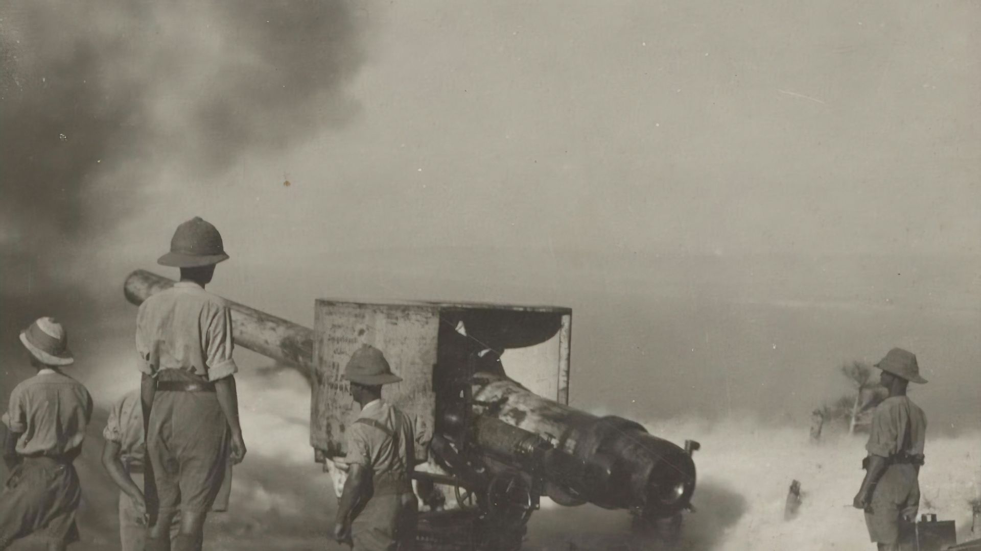 a group of men standing around a wrecked airplane