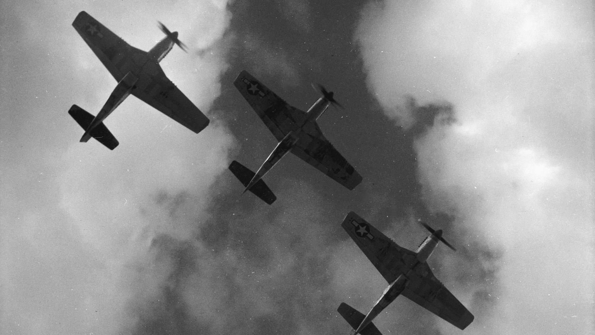 Four P-51 Mustangs flying in formation