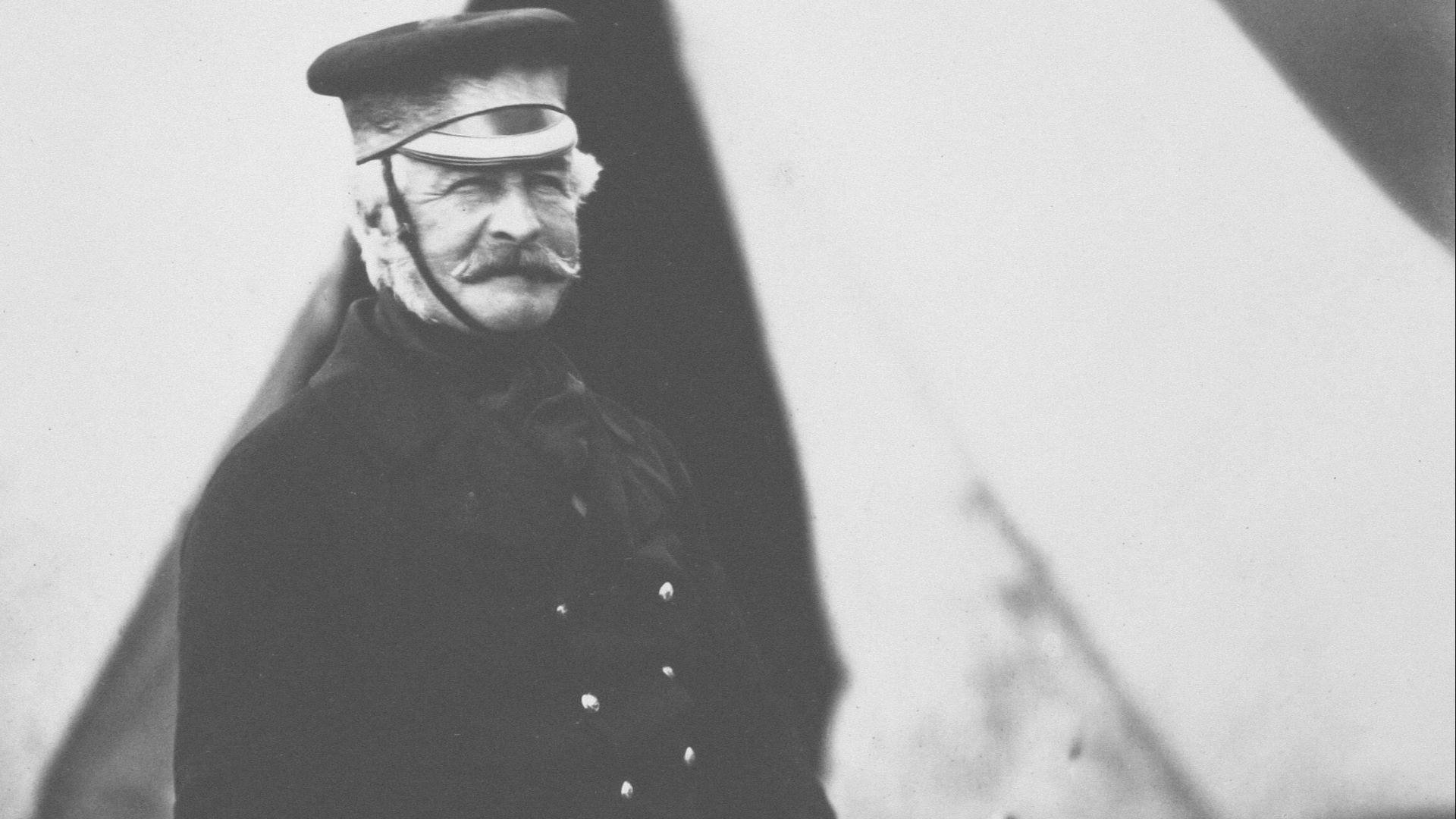 a black and white photo of a man in uniform