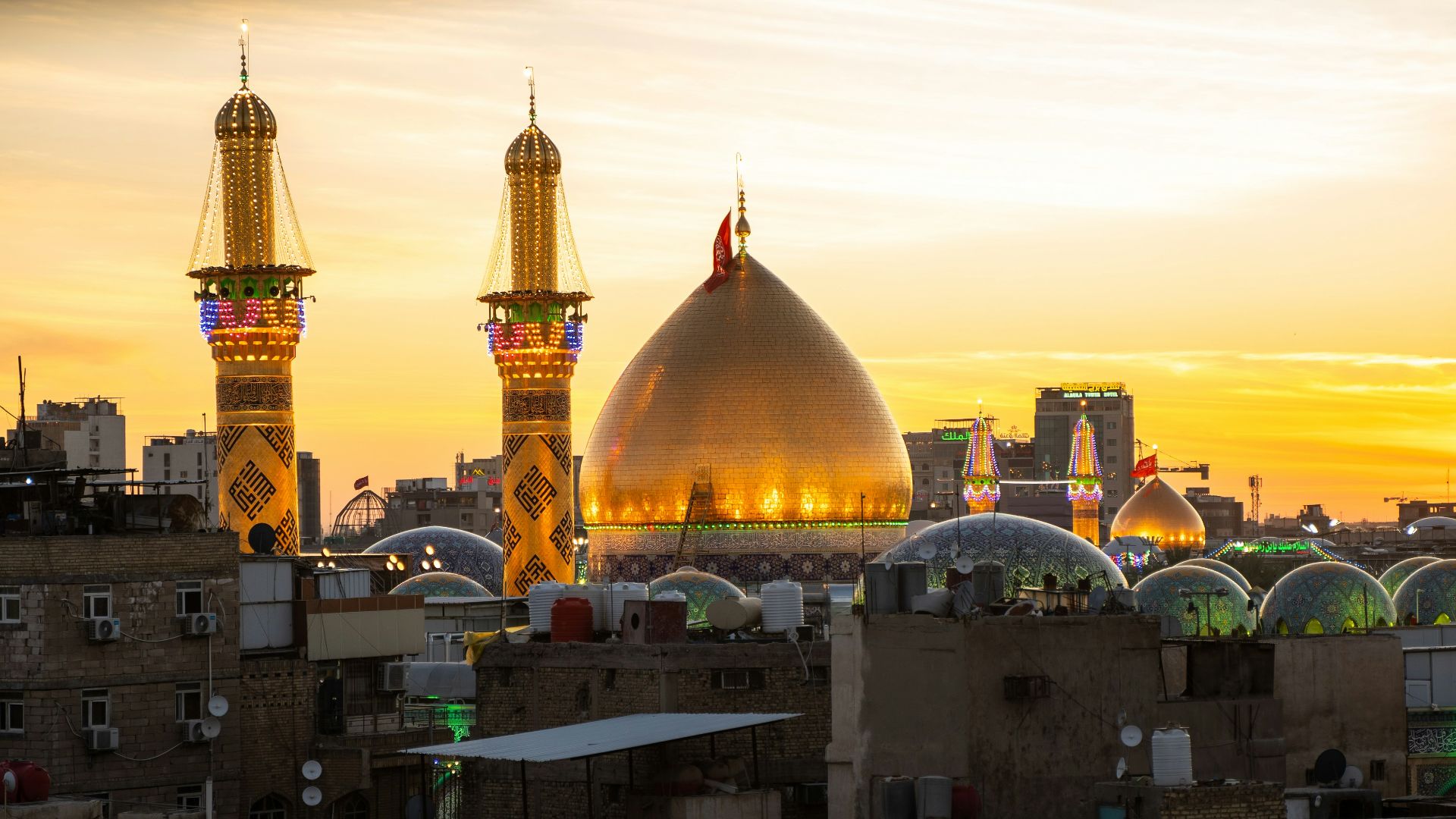 A sunset view of a city with tall buildings