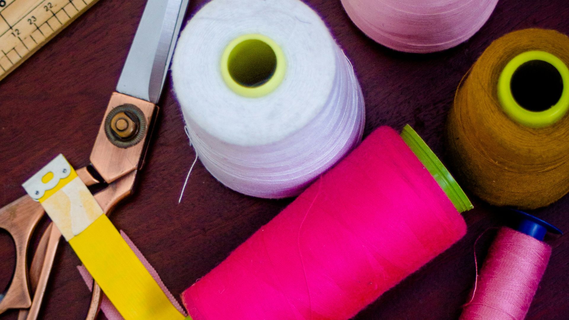 threads with spools beside scissors