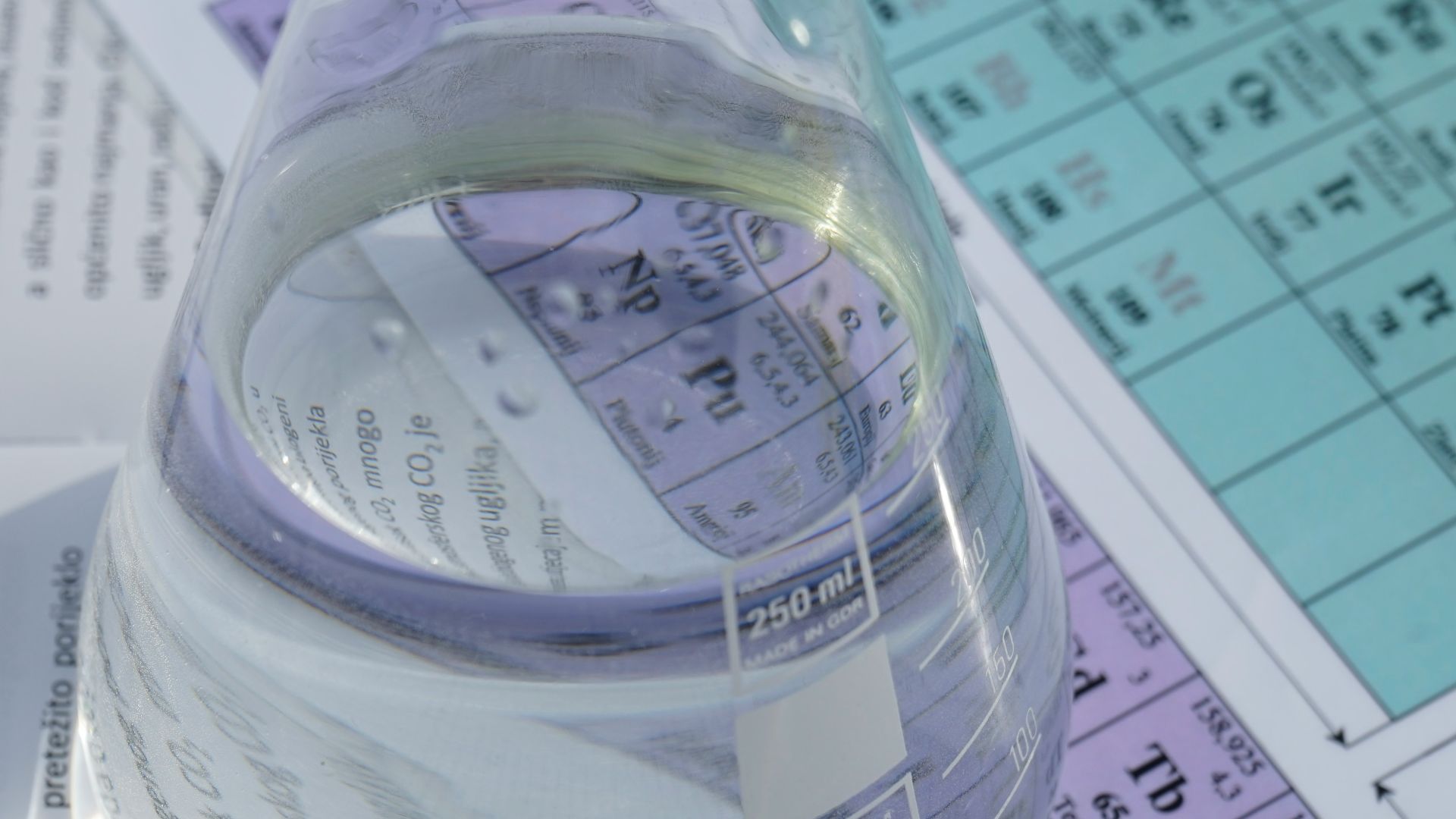 clear glass pitcher on white paper