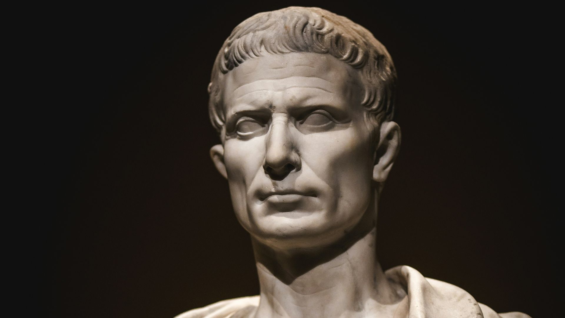 A bust of a man with a cape around his neck