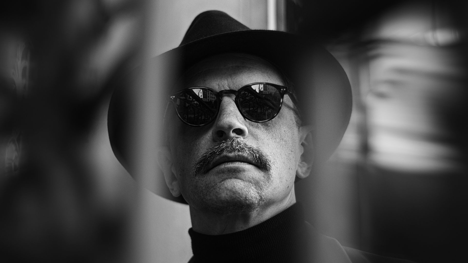 A man with a hat and sunglasses on