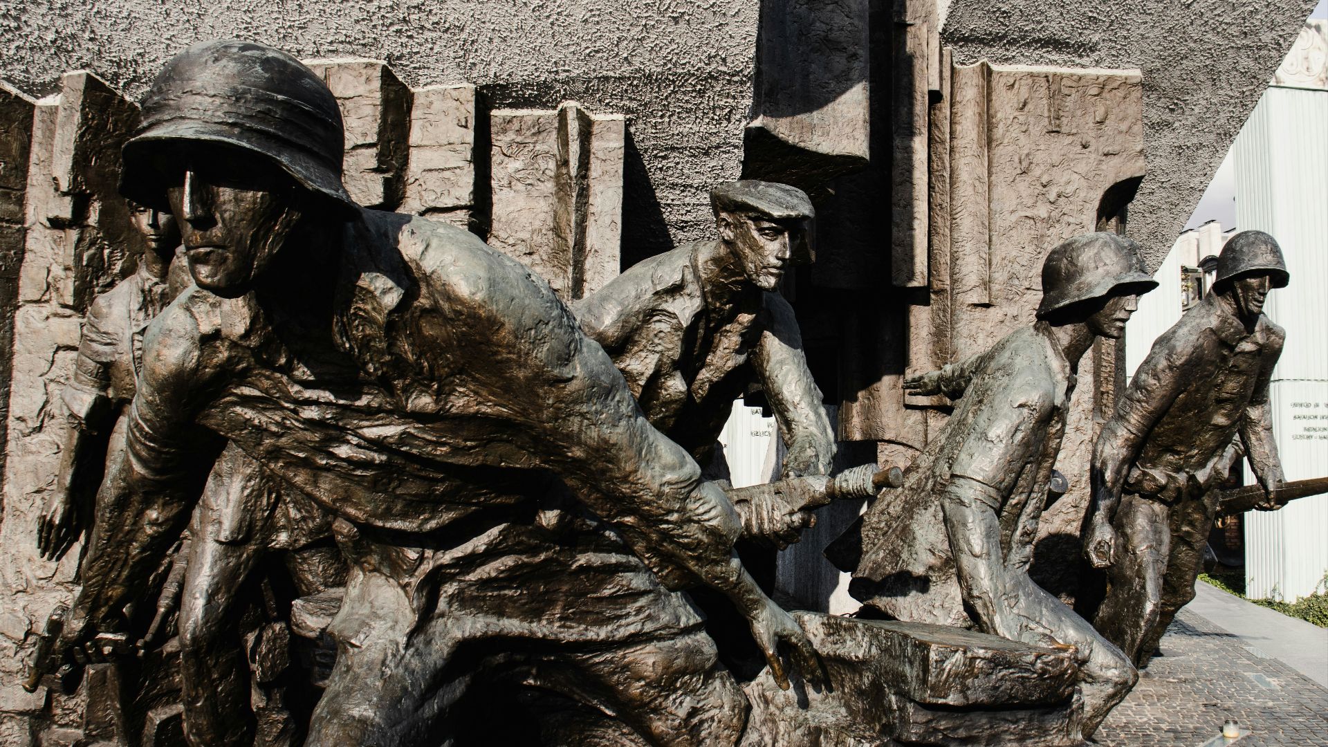 a statue of a group of men riding on top of each other