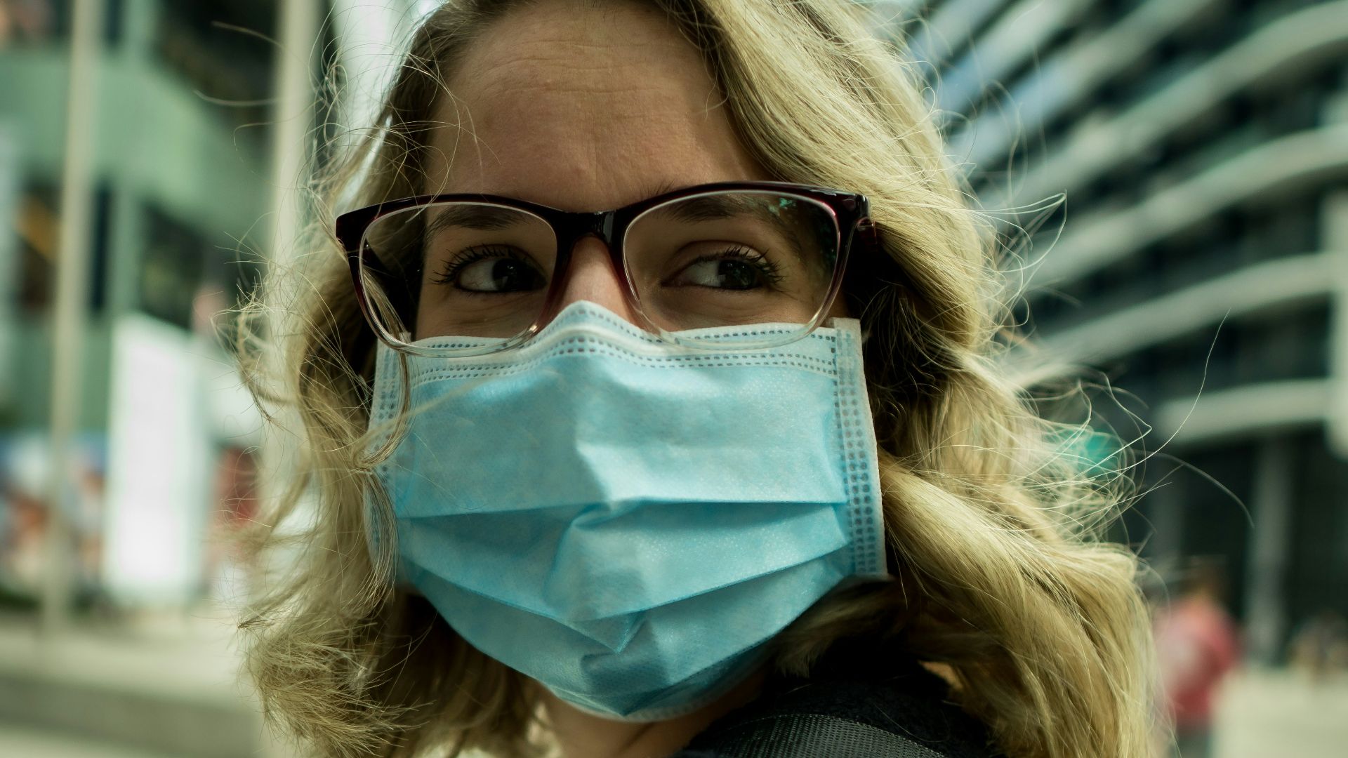 woman in black coat wearing eyeglasses