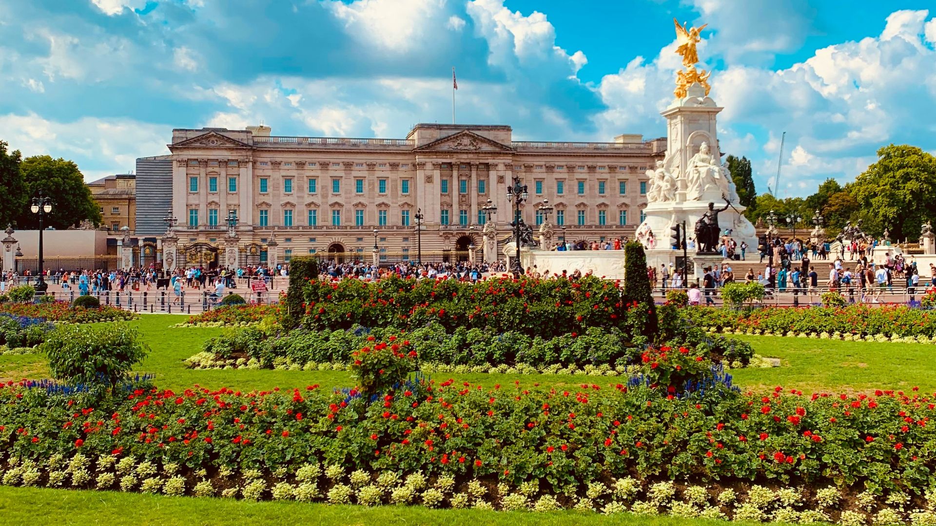 a large building with a statue in the middle of a garden