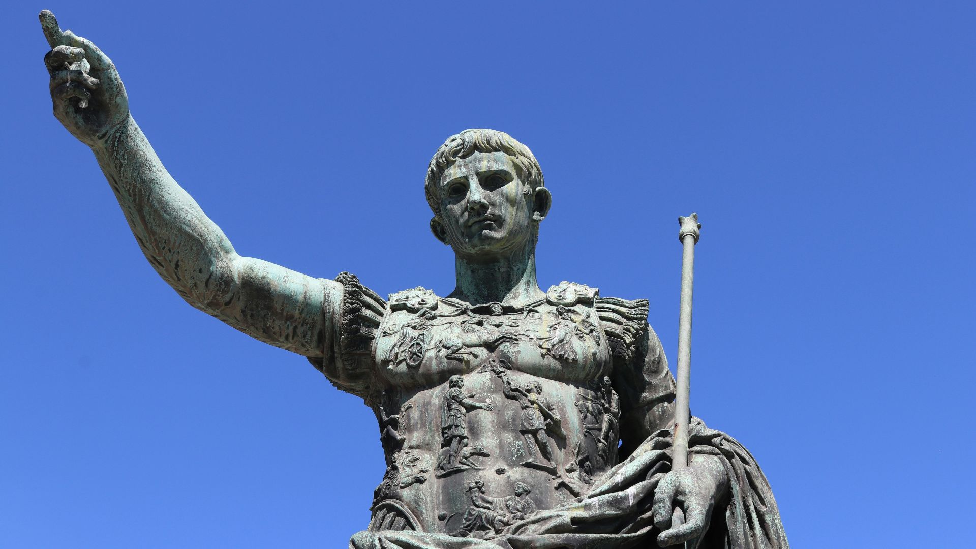 a statue of a person holding a staff