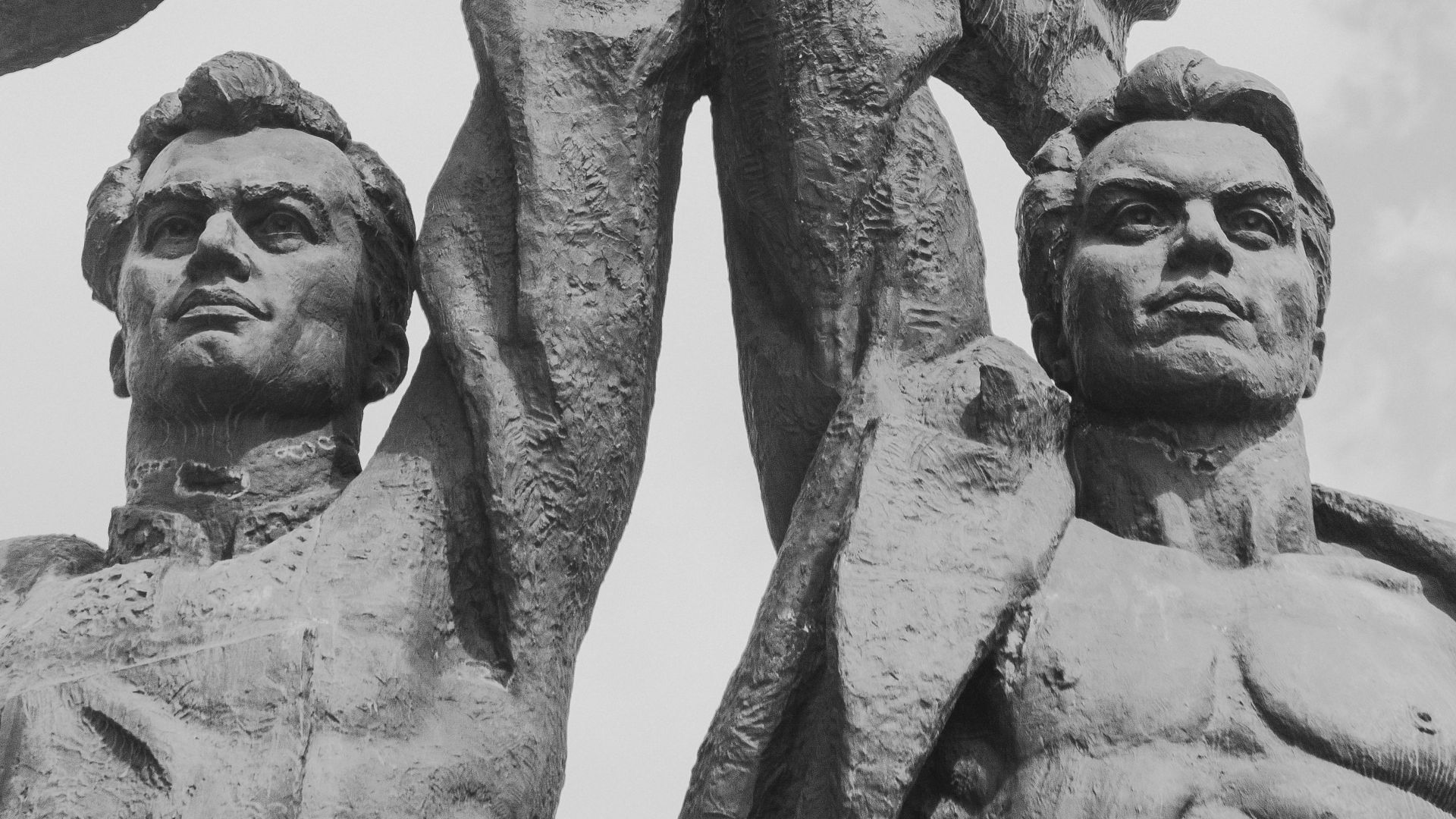 two men raising star statue