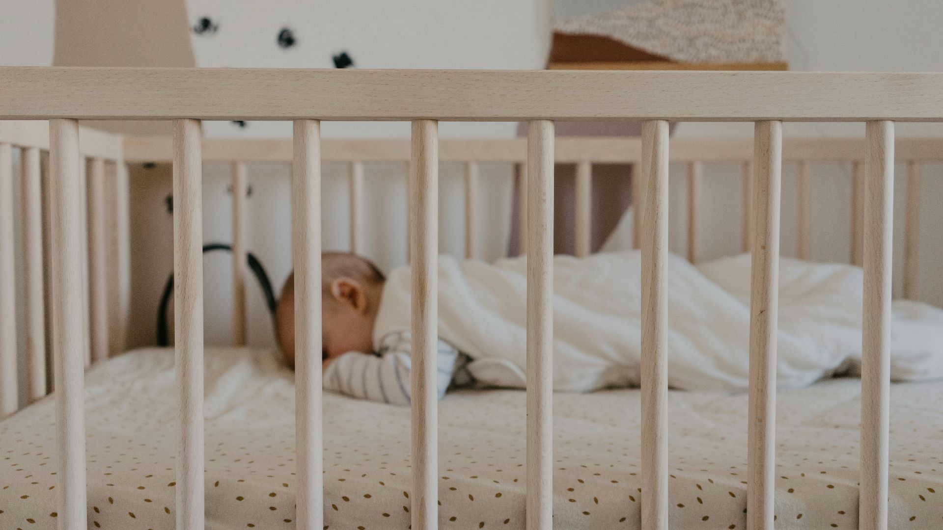 a person sleeping in a crib