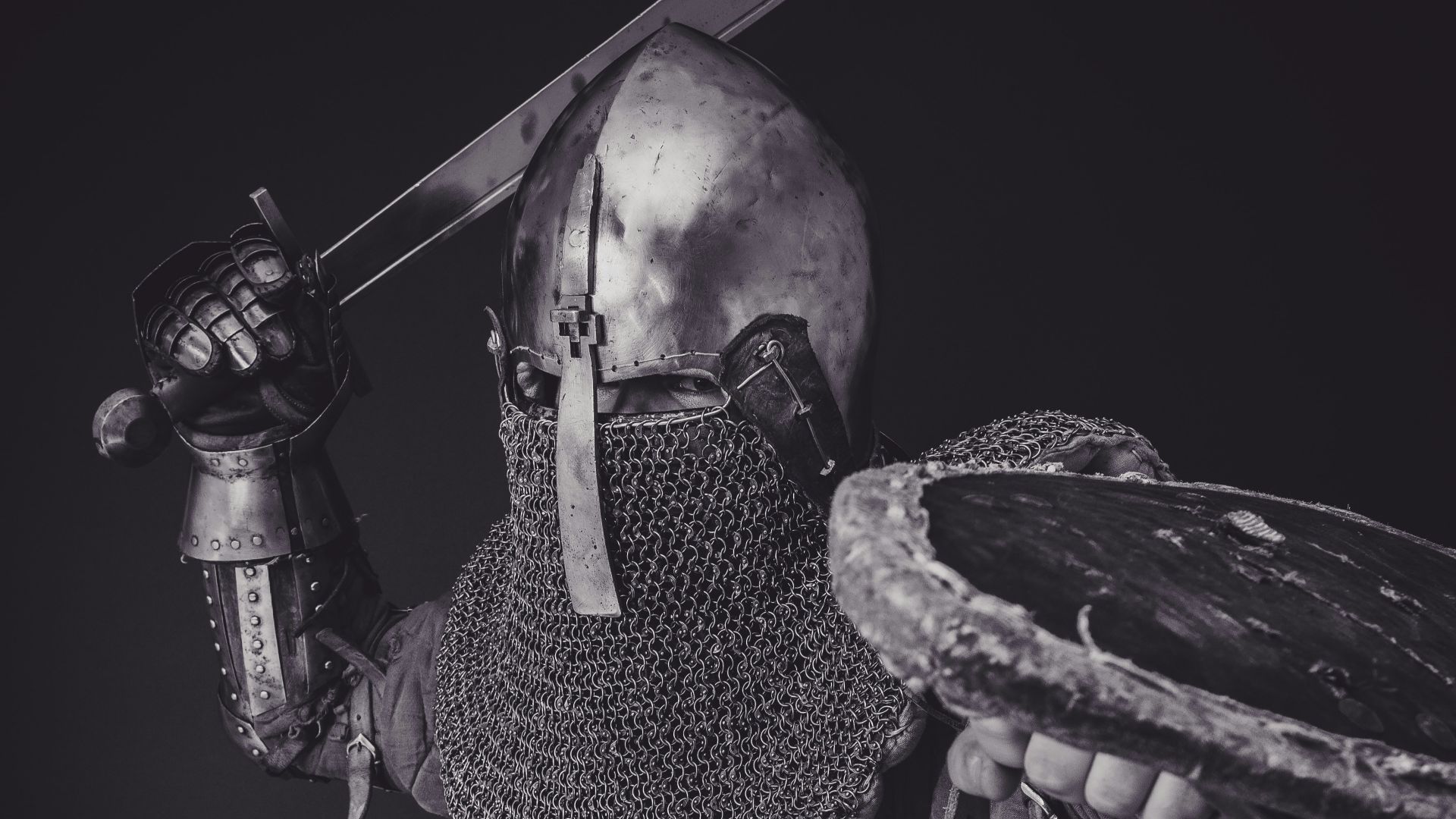 man with steel and chainmail armor holding sword