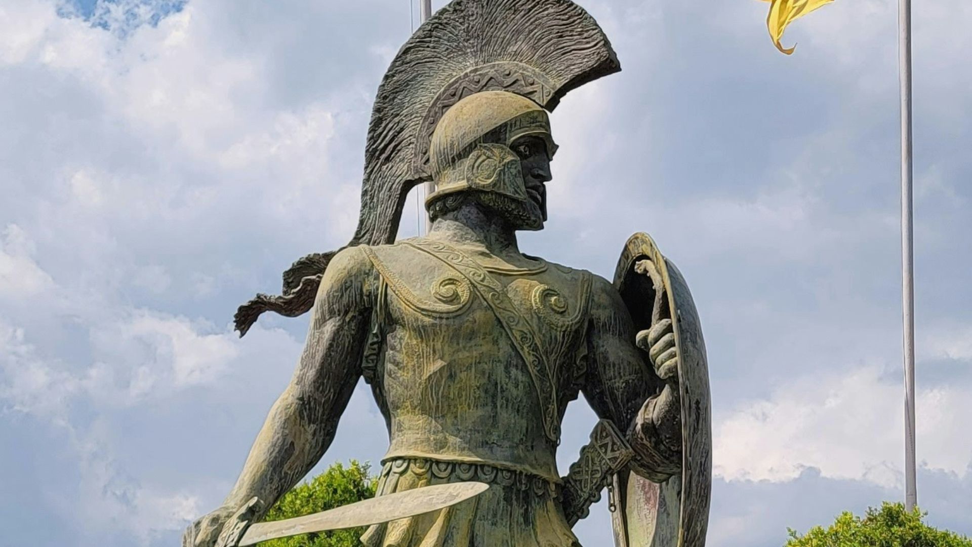 a statue of a man holding a shield and a shield