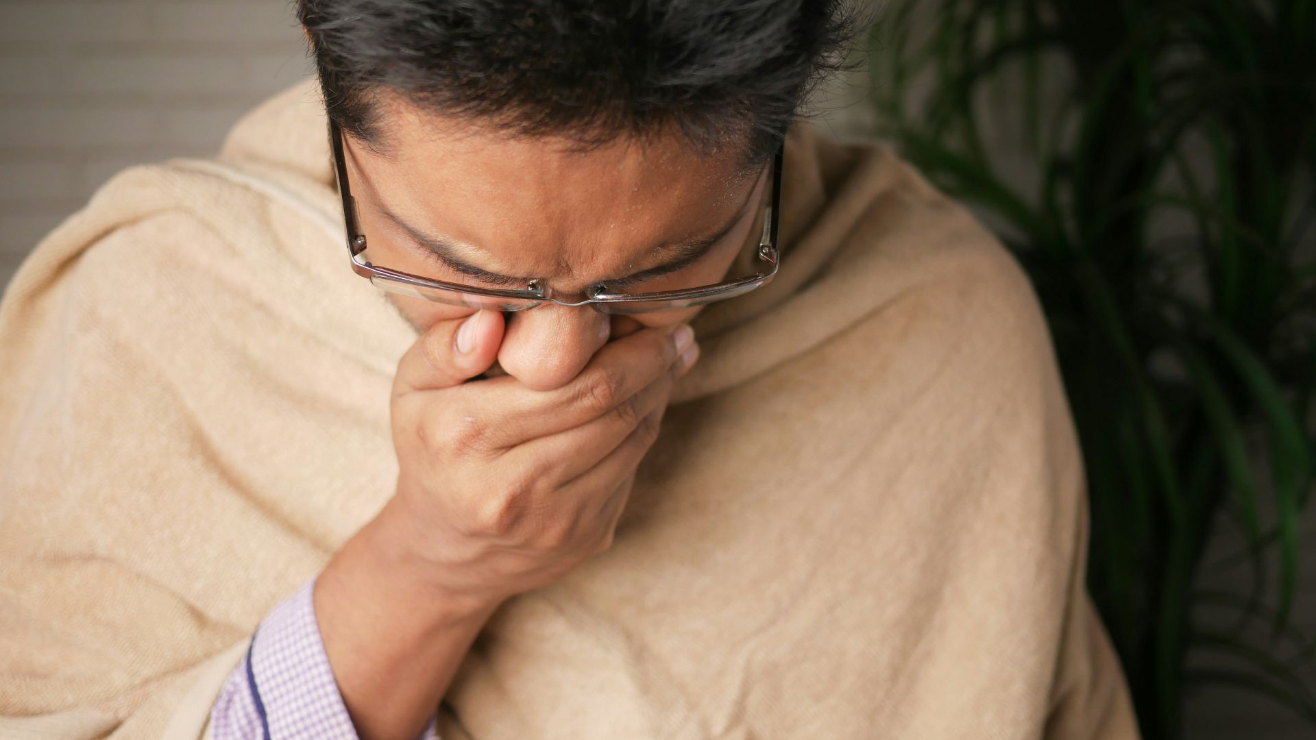 man in brown sweater wearing black framed eyeglasses