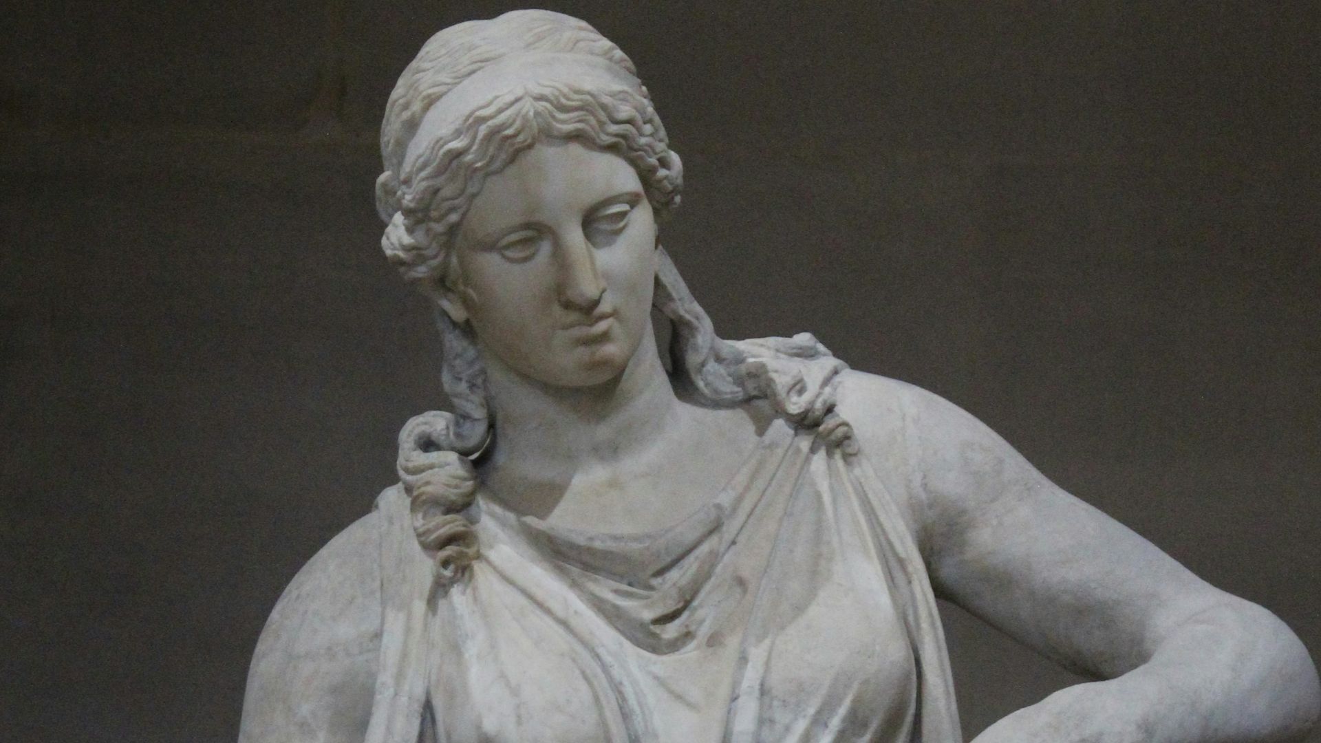 A marble statue of a classical female figure.