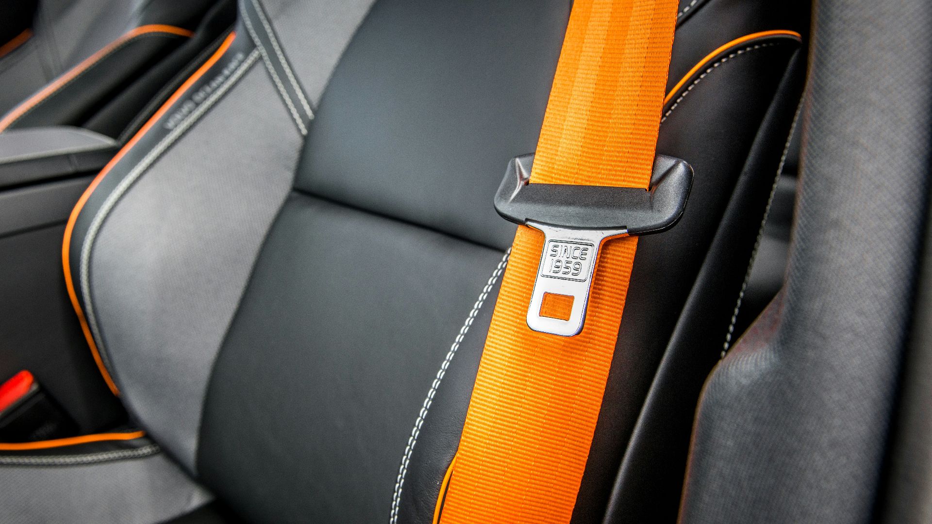orange and white belt on black leather seat