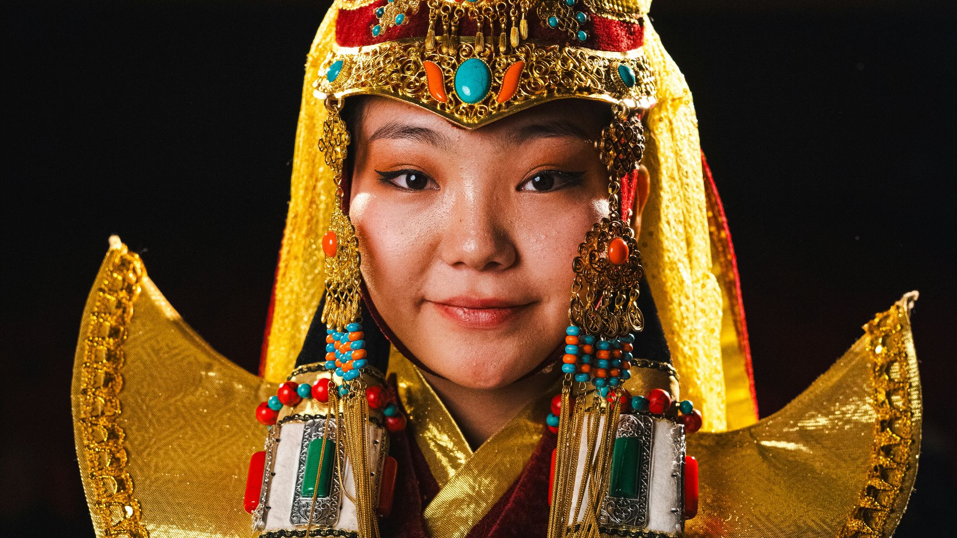 Woman in ornate traditional mongolian attire.