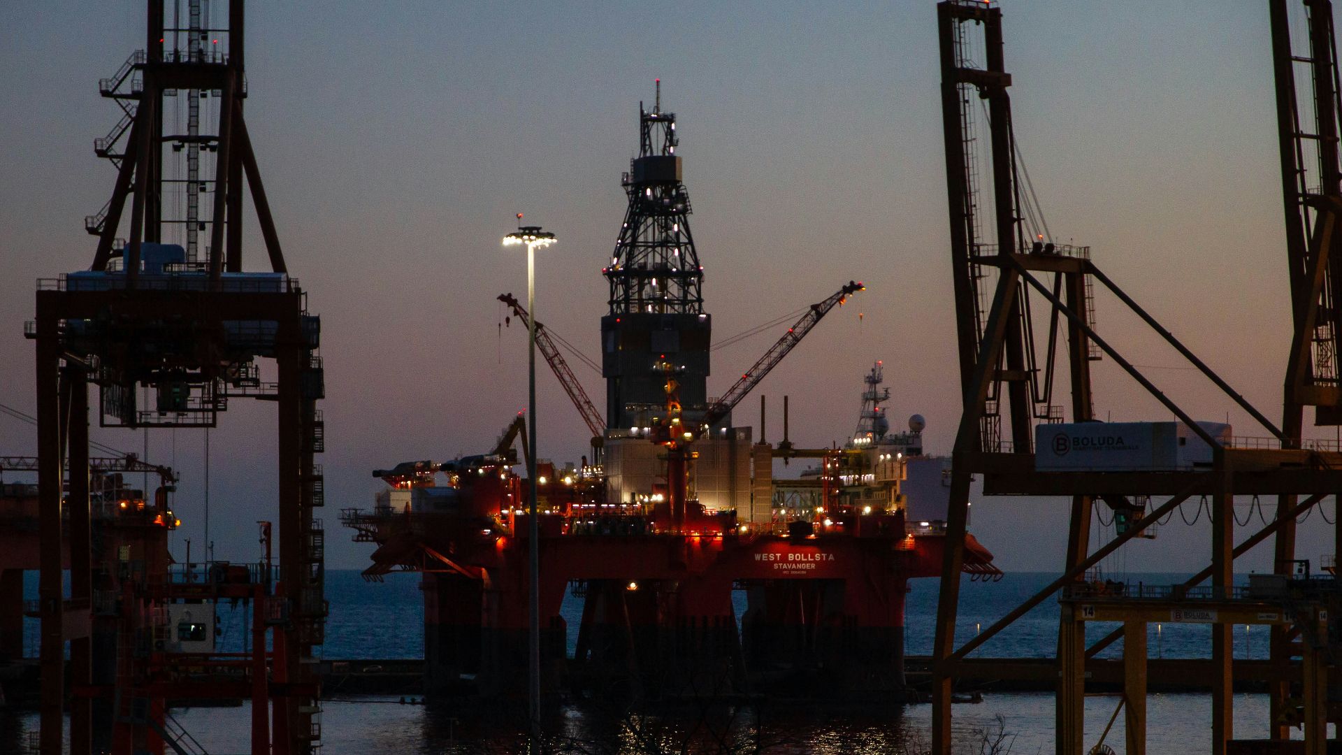 red and black metal tower during sunset