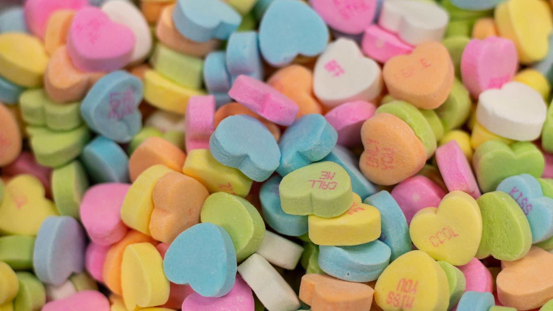 a pile of candy hearts sitting next to each other