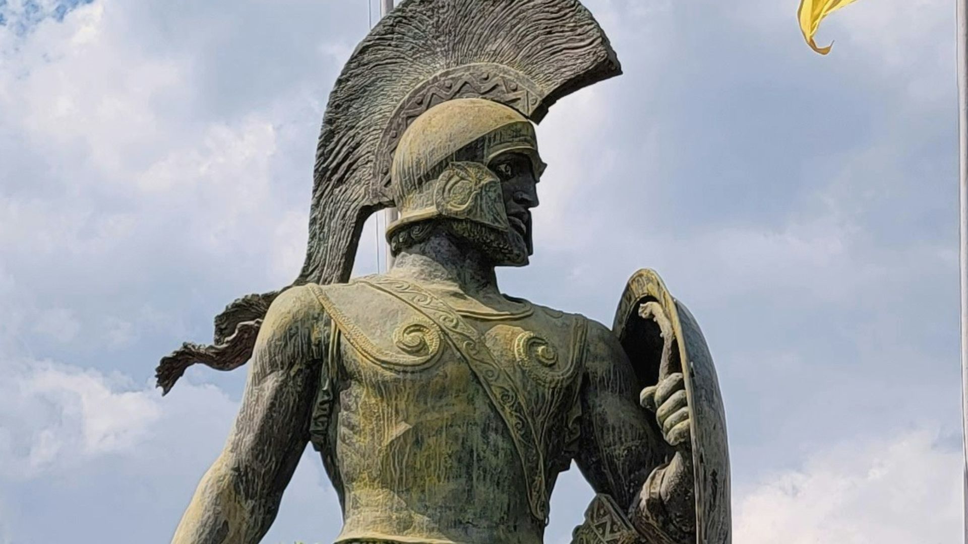a statue of a man holding a shield and a shield