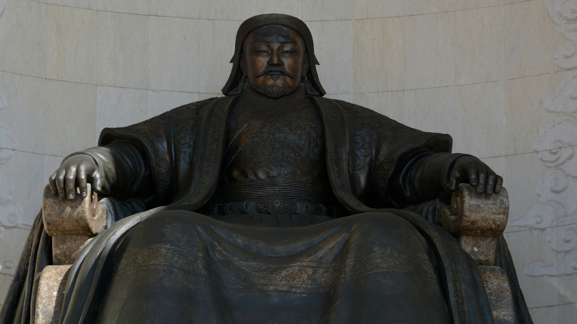 a statue of a man sitting in a chair