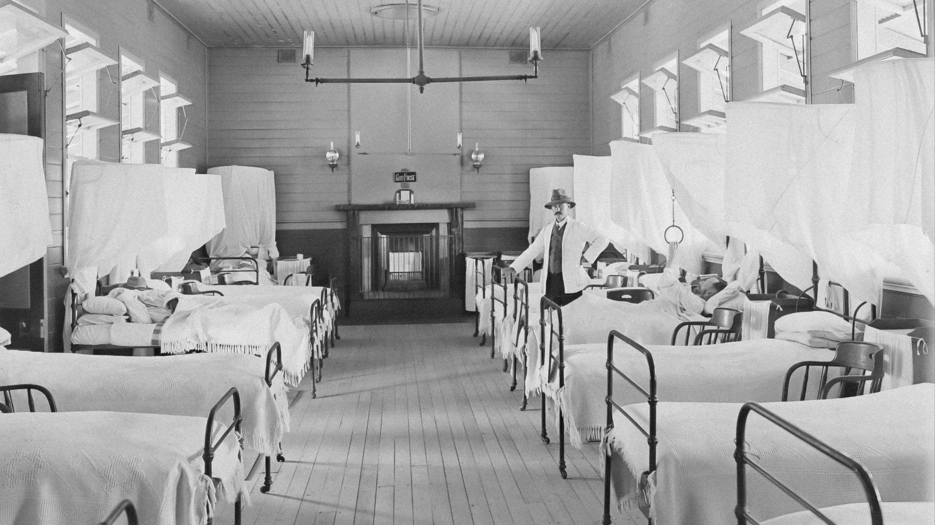 a black and white photo of a hospital room