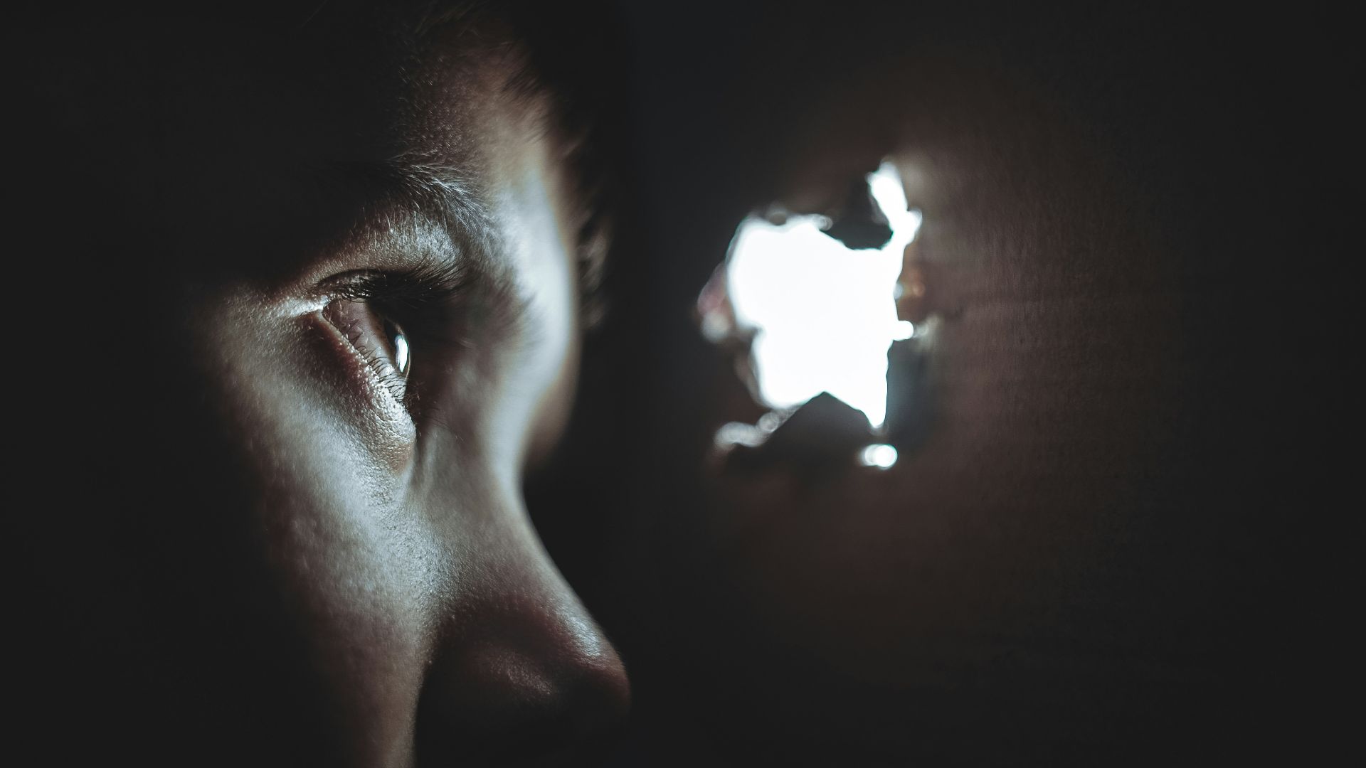 person watching through hole