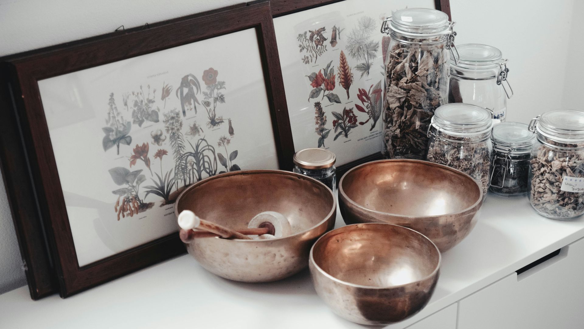 stainless steel bowls on table near framed photos