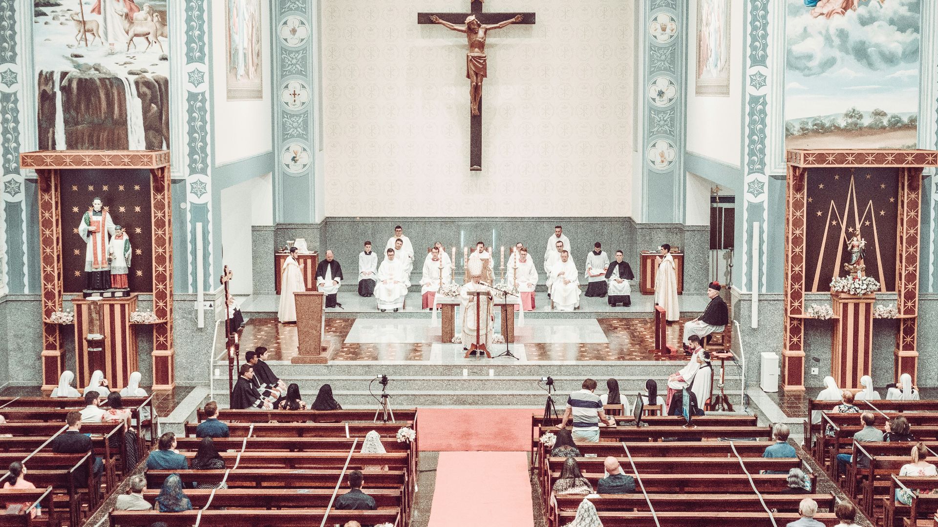 people sitting on red and white chairs inside church
