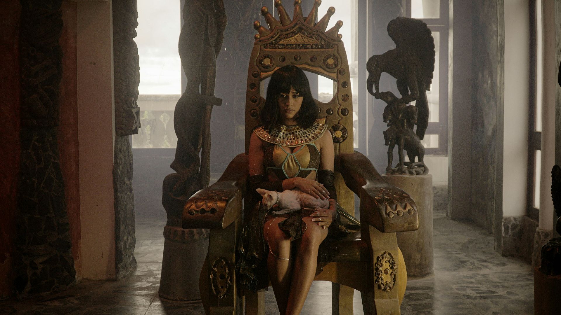 a woman sitting in a chair with a cat in her lap