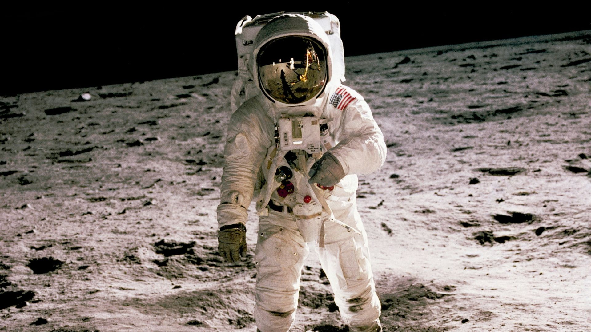 astronaut standing on gray sand