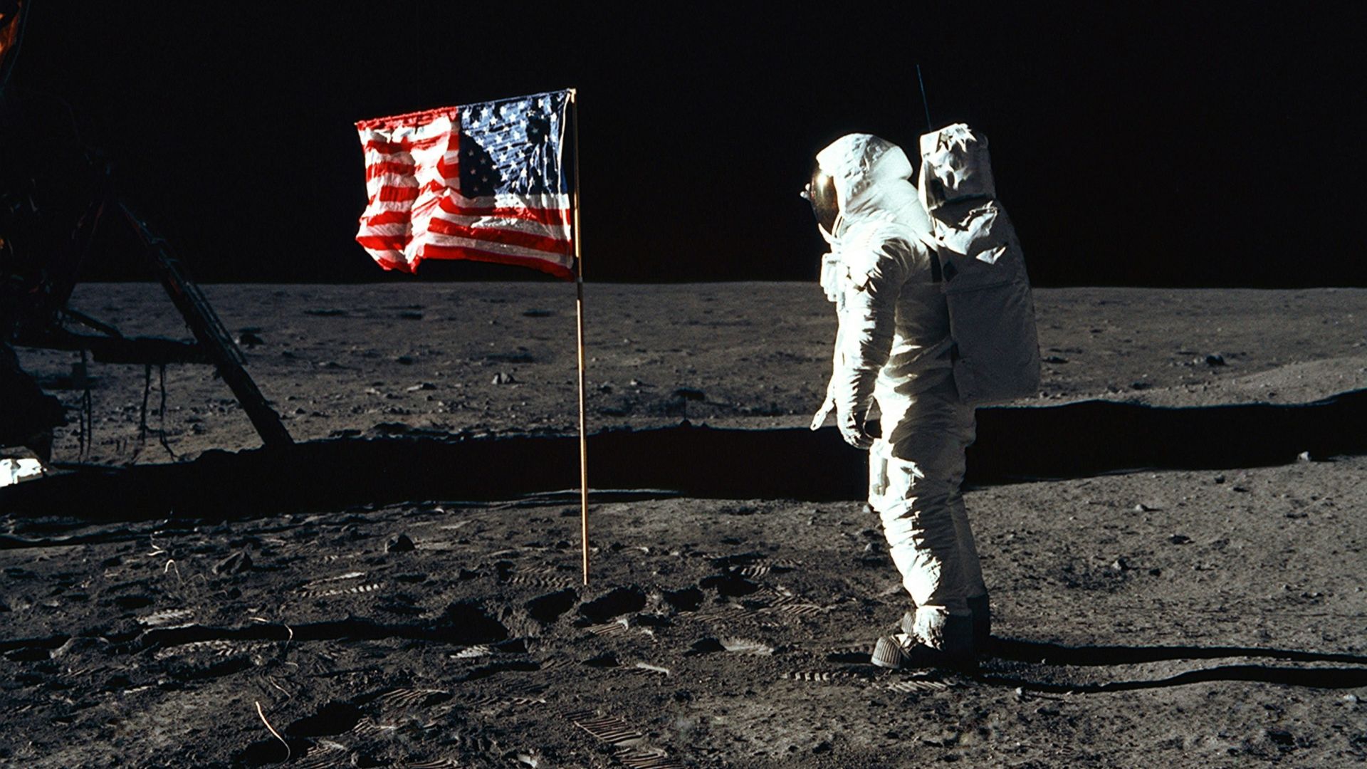 Buzz Aldrin on the moon in front of the US flag