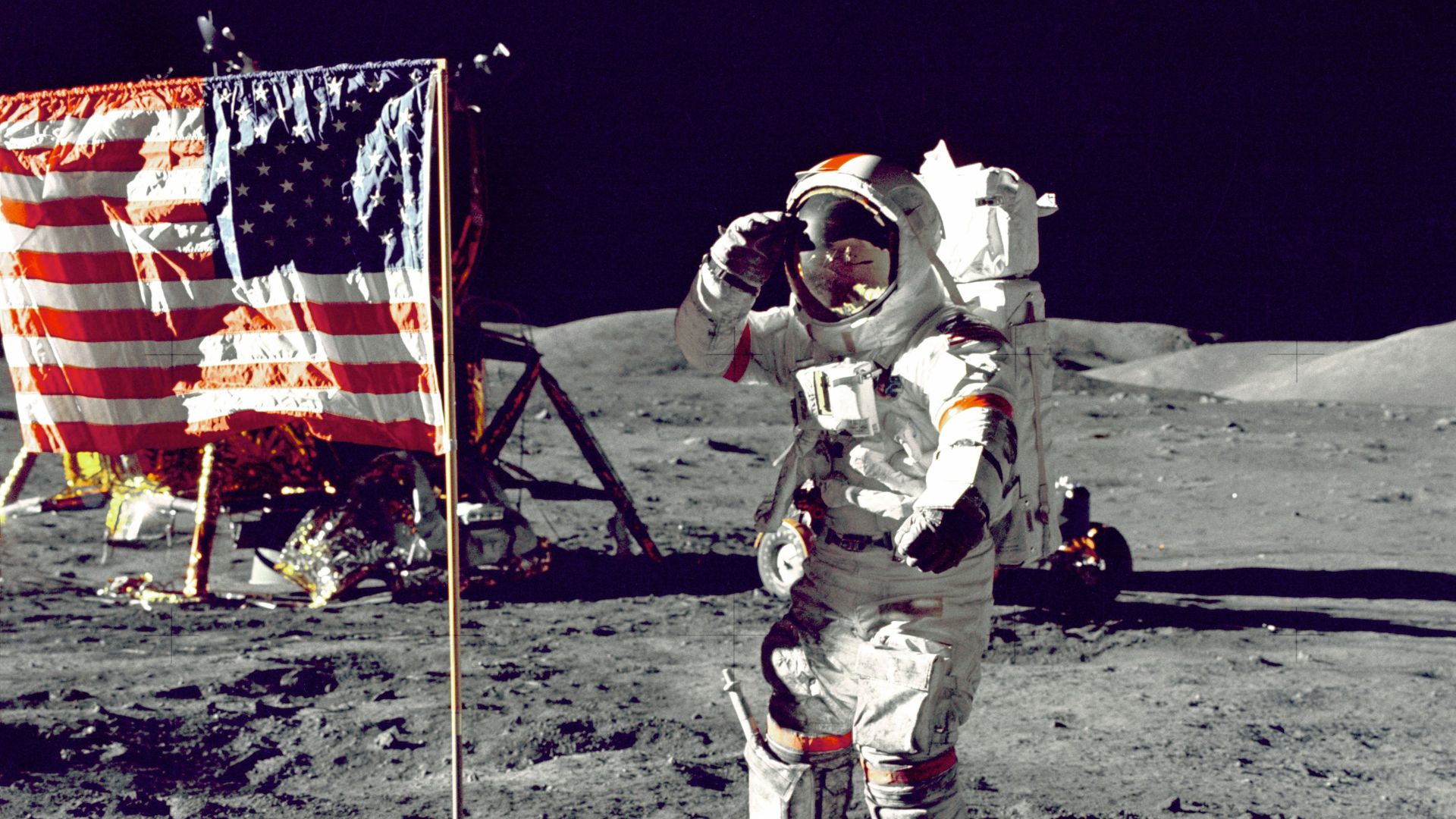 astronaut standing on moon beside U.S.A. flag
