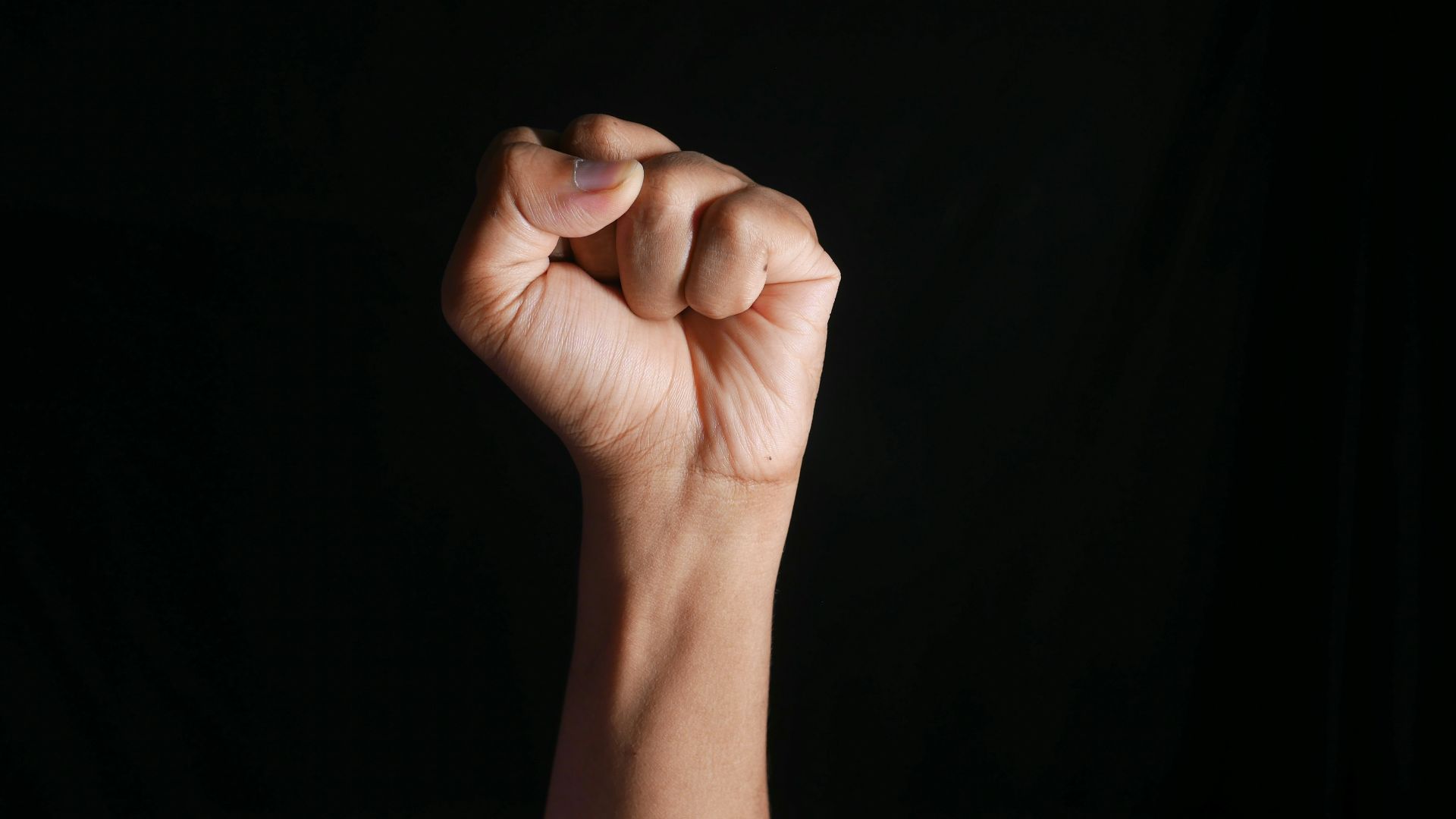 persons right hand doing fist gesture