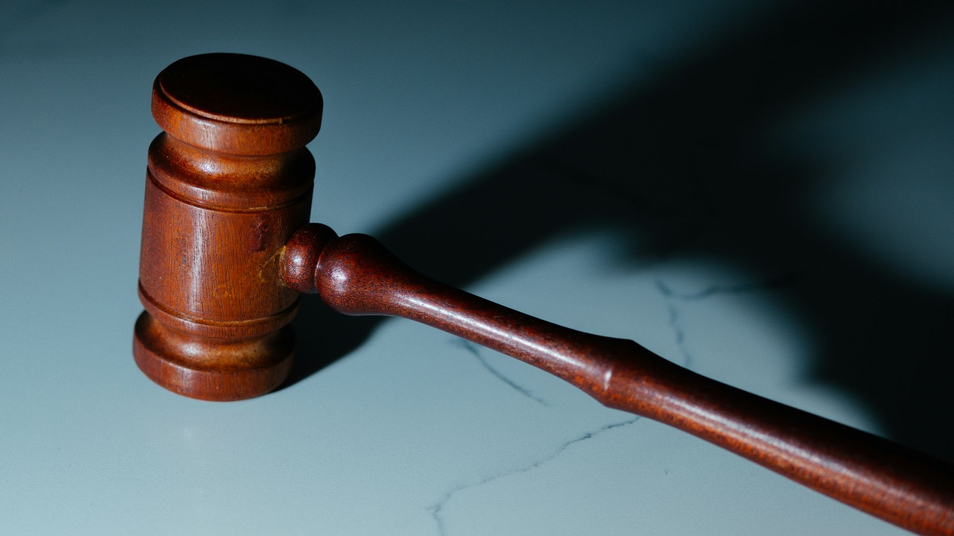 a wooden judge's hammer sitting on top of a table