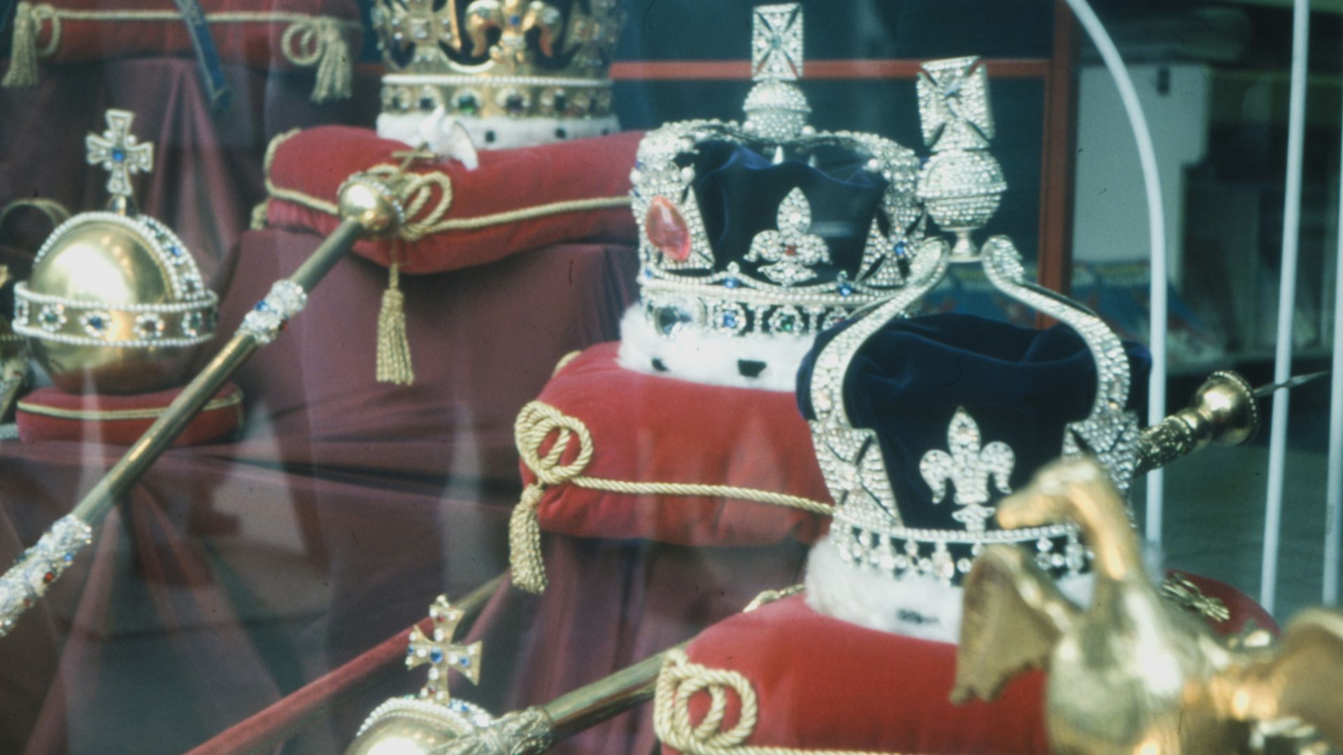 gold and red trophy on glass shelf