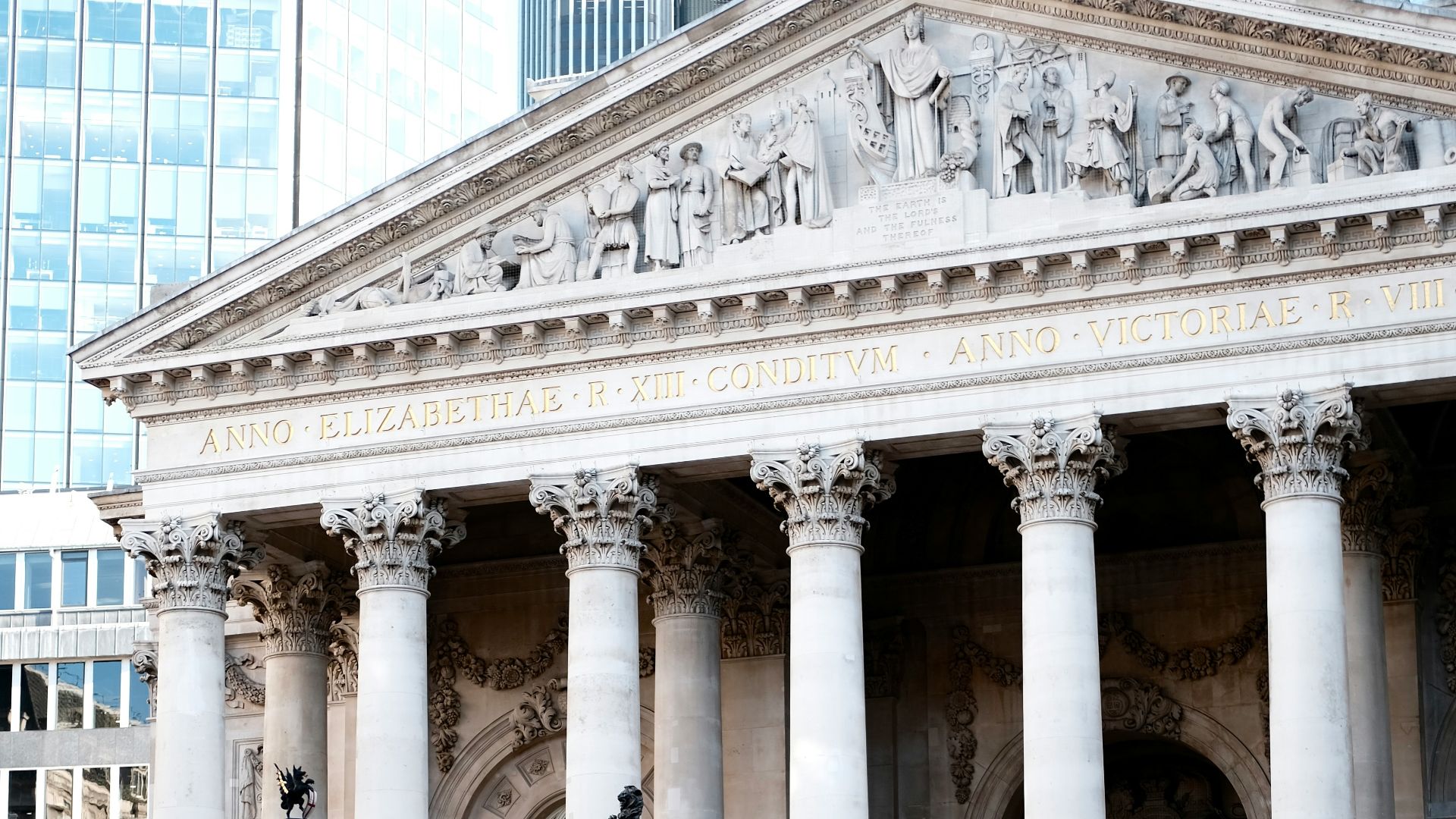a man walking down the street in front of a building