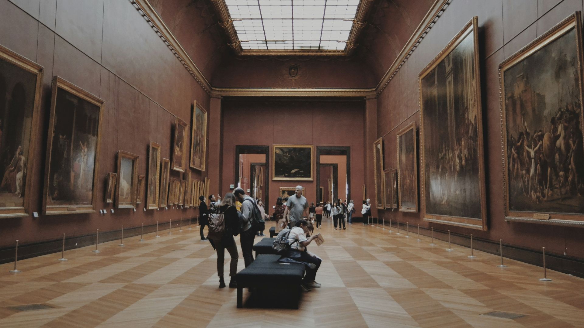 people walking on corridor looking at painting