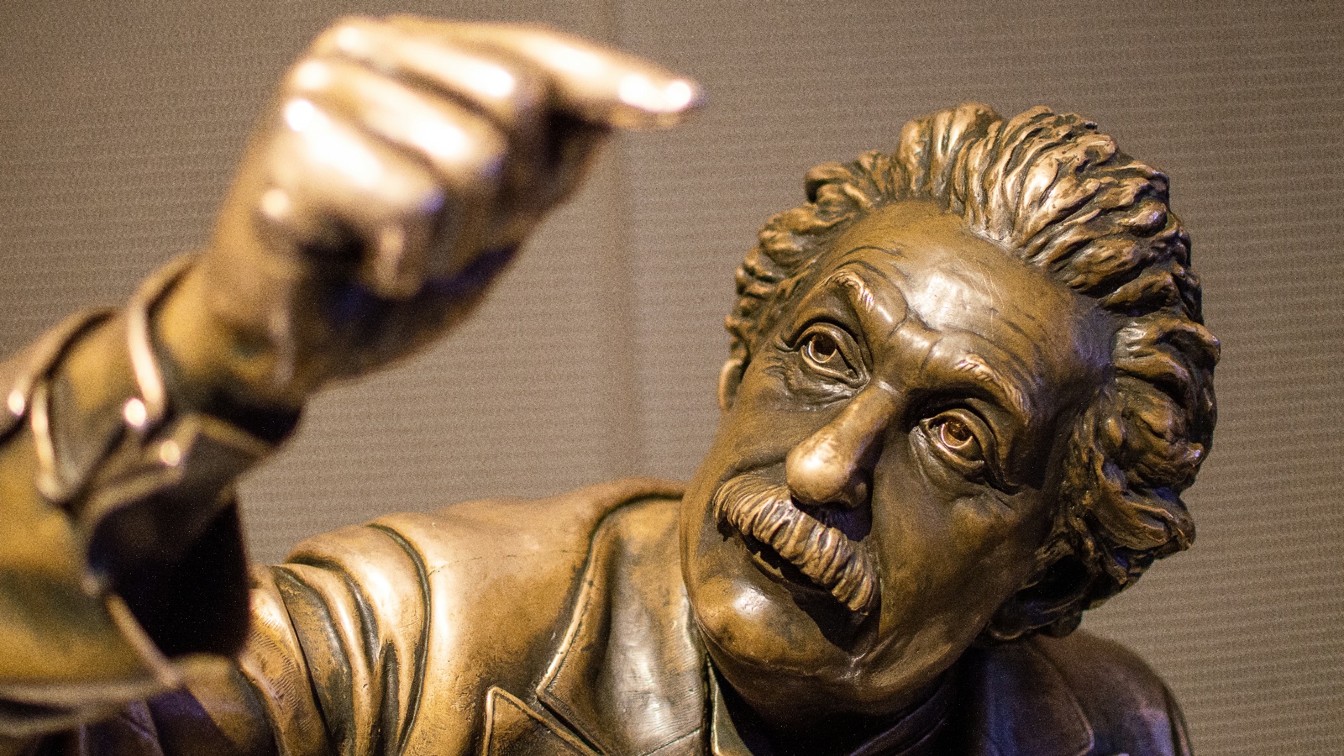 mans face carved on brown concrete wall