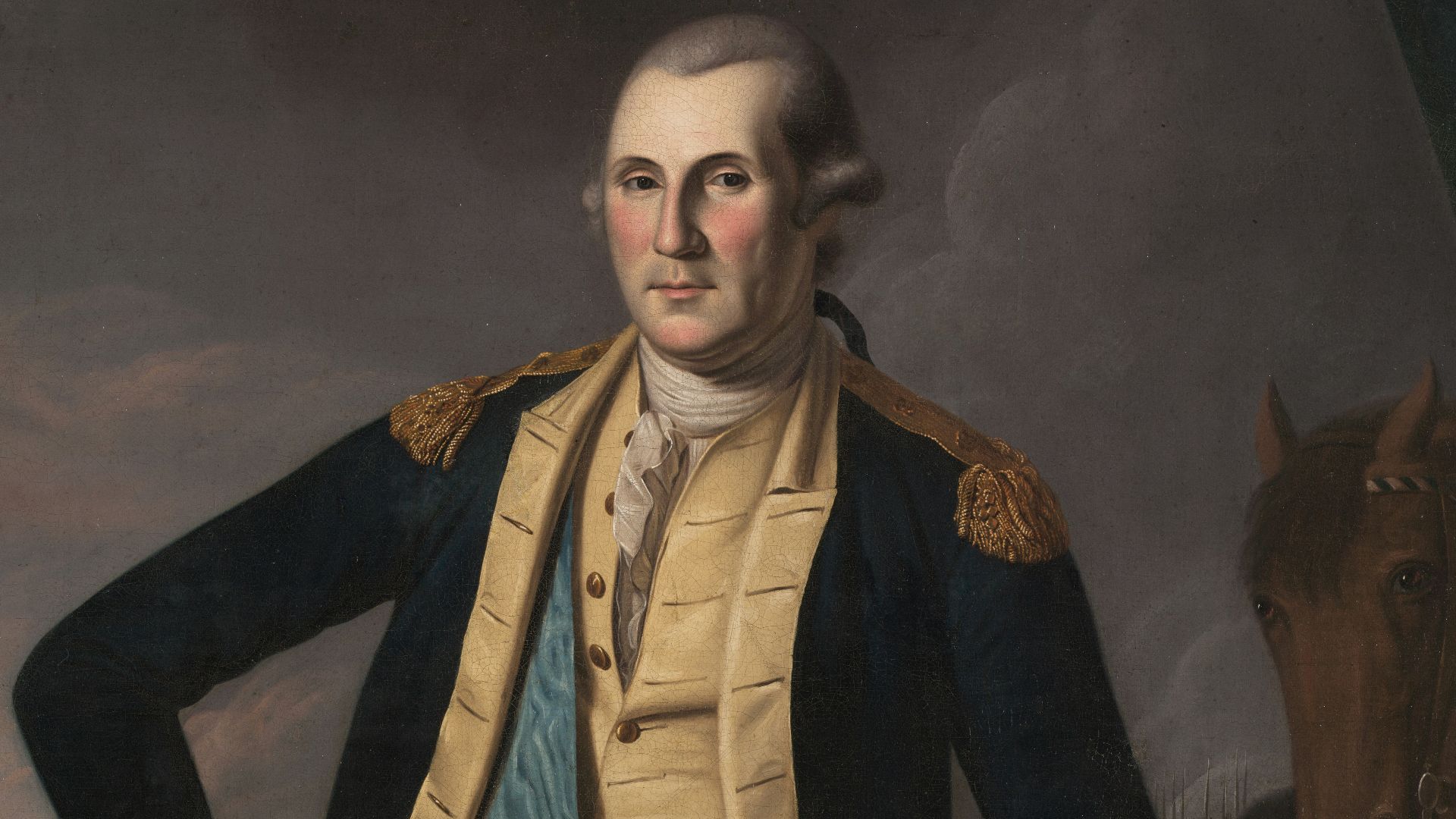 George washington in military uniform with cannon.